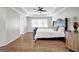 Bedroom featuring hardwood floors, neutral walls, a decorative headboard, and tray ceilings at 3139 Players Dr, Jonesboro, GA 30236