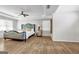 Large bedroom featuring hardwood floors, neutral walls, a decorative headboard, and tray ceilings at 3139 Players Dr, Jonesboro, GA 30236