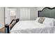 Bedroom featuring hardwood floors, neutral walls, a decorative headboard, and a closet in the background at 3139 Players Dr, Jonesboro, GA 30236