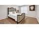 Bedroom with a decorative headboard, neutral walls, hardwood floors, a large window, and artwork at 3139 Players Dr, Jonesboro, GA 30236