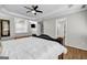 Large bedroom featuring hardwood floors, tray ceilings, neutral walls, and a decorative headboard at 3139 Players Dr, Jonesboro, GA 30236