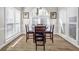 Bright dining room with large window and a dark wood table at 3139 Players Dr, Jonesboro, GA 30236