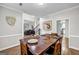 Bright dining room featuring a modern table with chair seating and views to foyer and kitchen at 3139 Players Dr, Jonesboro, GA 30236