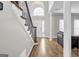 View of foyer with stairway featuring wood floors, banister, and large, arched front door window at 3139 Players Dr, Jonesboro, GA 30236