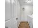View of a laundry room with white walls, hardwood floors, a washer and dryer, and a small sign at 3139 Players Dr, Jonesboro, GA 30236