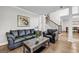 View of the living room and stair case with a sofa, armchair, wood floors, and natural light at 3139 Players Dr, Jonesboro, GA 30236