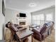 View of living room with multiple recliners, fireplace, and bright window light at 3139 Players Dr, Jonesboro, GA 30236