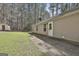 Backyard featuring a grassy area, mature trees, and a view of the home's exterior at 1109 Allen Rd, Grantville, GA 30220