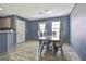 Dining room with a wood table and chairs, wood floors, and a modern light fixture at 1109 Allen Rd, Grantville, GA 30220