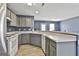 Spacious kitchen with white appliances, grey cabinets, a breakfast bar, and tile floors at 1109 Allen Rd, Grantville, GA 30220
