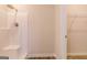 Shower stall with white tile, and a built-in seat, next to a walk-in closet at 502 Alford Cv # 91, Fairburn, GA 30213