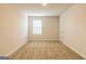 Bedroom with a window providing natural light and neutral carpeting throughout at 502 Alford Cv # 91, Fairburn, GA 30213