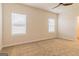 Cozy bedroom with neutral carpet, two windows letting in natural light and a ceiling fan at 502 Alford Cv # 91, Fairburn, GA 30213