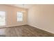Bright dining area with hardwood floors, a modern chandelier, and natural light from the window at 502 Alford Cv # 91, Fairburn, GA 30213