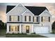 Charming two-story brick home with a well-manicured lawn and a welcoming two-car garage at 502 Alford Cv # 91, Fairburn, GA 30213