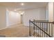 Upstairs hallway with neutral carpet and stairway with contemporary railings at 502 Alford Cv # 91, Fairburn, GA 30213