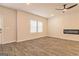 Cozy living room featuring hardwood floors, a modern ceiling fan, and a sleek electric fireplace at 502 Alford Cv # 91, Fairburn, GA 30213