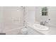 Bathroom featuring a shower and bath combination, vanity and window at 385 Lakeshore Dr, Stockbridge, GA 30281