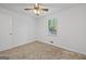 Bedroom with neutral carpet, a ceiling fan with light fixture, and a window view at 385 Lakeshore Dr, Stockbridge, GA 30281