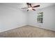 Bedroom featuring neutral carpet, a ceiling fan with light fixture, and a window at 385 Lakeshore Dr, Stockbridge, GA 30281