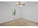 Bedroom featuring carpeted flooring, neutral walls, ceiling fan and bright natural light at 385 Lakeshore Dr, Stockbridge, GA 30281