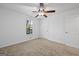Bedroom featuring neutral carpet, a ceiling fan with light fixture, and a window at 385 Lakeshore Dr, Stockbridge, GA 30281