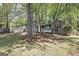A single-story house with a lush lawn and mature trees in the front yard at 385 Lakeshore Dr, Stockbridge, GA 30281