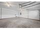 Spacious garage featuring white doors, concrete floor and interior access at 385 Lakeshore Dr, Stockbridge, GA 30281