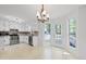 Bright kitchen with white cabinets, stainless steel appliances, and a charming chandelier at 385 Lakeshore Dr, Stockbridge, GA 30281