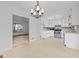 Kitchen featuring white cabinets, stainless steel appliances, and a view into the living room at 385 Lakeshore Dr, Stockbridge, GA 30281