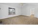 Well-lit living room featuring neutral carpet and a large window at 385 Lakeshore Dr, Stockbridge, GA 30281
