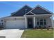 Charming brick home featuring a two-car garage and well-manicured lawn at 591 Parnassus Rd, Locust Grove, GA 30248
