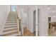 Well-lit stairway with wood treads and white risers, providing access to upper levels at 591 Parnassus Rd, Locust Grove, GA 30248