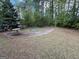 Backyard features a rundown in-ground pool surrounded by a concrete patio in a wooded setting at 9041 Southcrest Ct, Jonesboro, GA 30238