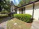 Side view of a split-level home with stone accents and walkway leading to the front entrance at 9041 Southcrest Ct, Jonesboro, GA 30238