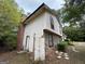 Exterior of split-level home featuring a brick chimney and stone accents at 9041 Southcrest Ct, Jonesboro, GA 30238