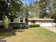 Charming split-level home with stone accents, well-maintained lawn, and an attached two-car garage at 9041 Southcrest Ct, Jonesboro, GA 30238