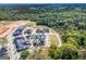 An aerial view of new construction homes in a neighborhood with wooded areas and landscaping at 1461 Thomas St, Conyers, GA 30094