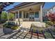 Covered porch with white brick stairs and detailed landscaping leading to the backyard at 1461 Thomas St, Conyers, GA 30094