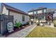 Backyard with stepping stone walkway, flowering garden, outbuilding and black pergola at 1461 Thomas St, Conyers, GA 30094