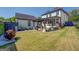 Large backyard with grass, black pergola and additional outbuilding at 1461 Thomas St, Conyers, GA 30094