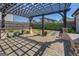 Backyard brick patio with black pergola and fenced yard with green grass at 1461 Thomas St, Conyers, GA 30094