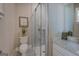 Well-lit bathroom showcases a glass-door shower, toilet, and vanity with granite counters, plus decorative elements at 1461 Thomas St, Conyers, GA 30094