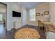 Cozy bedroom featuring dark hardwood floors, a mounted TV, an area rug, and a window with natural light at 1461 Thomas St, Conyers, GA 30094