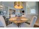 Bright breakfast nook with marble table, view into living room, and contemporary light fixture at 1461 Thomas St, Conyers, GA 30094