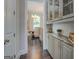 Chandelier-lit dining room with hardwood floors, a decorative hutch, and view into the dining area at 1461 Thomas St, Conyers, GA 30094