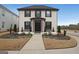 Charming two-story brick home featuring a landscaped yard, covered entrance, and black window shutters at 1461 Thomas St, Conyers, GA 30094