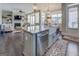 Open-concept kitchen with stainless steel appliances, large island, and view into living area at 1461 Thomas St, Conyers, GA 30094