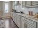 Well-lit kitchen features granite counters, dark wood floors, and stainless steel appliances, and a tiled backsplash at 1461 Thomas St, Conyers, GA 30094