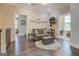 Cozy living room with seating, decorative accents, and view to the laundry room at 1461 Thomas St, Conyers, GA 30094